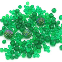 Green plastic bead mix has 145 rounds and tri-beads. Sizes range from 6mm to 15mm.