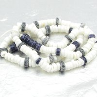 15 inch strand of vintage heishi beads has 189 flat, round beads center-drilled with 1mm holes. The strand rustic, unfaceted rondelles has 35 dark blue and 154 opaque white glass beads. 