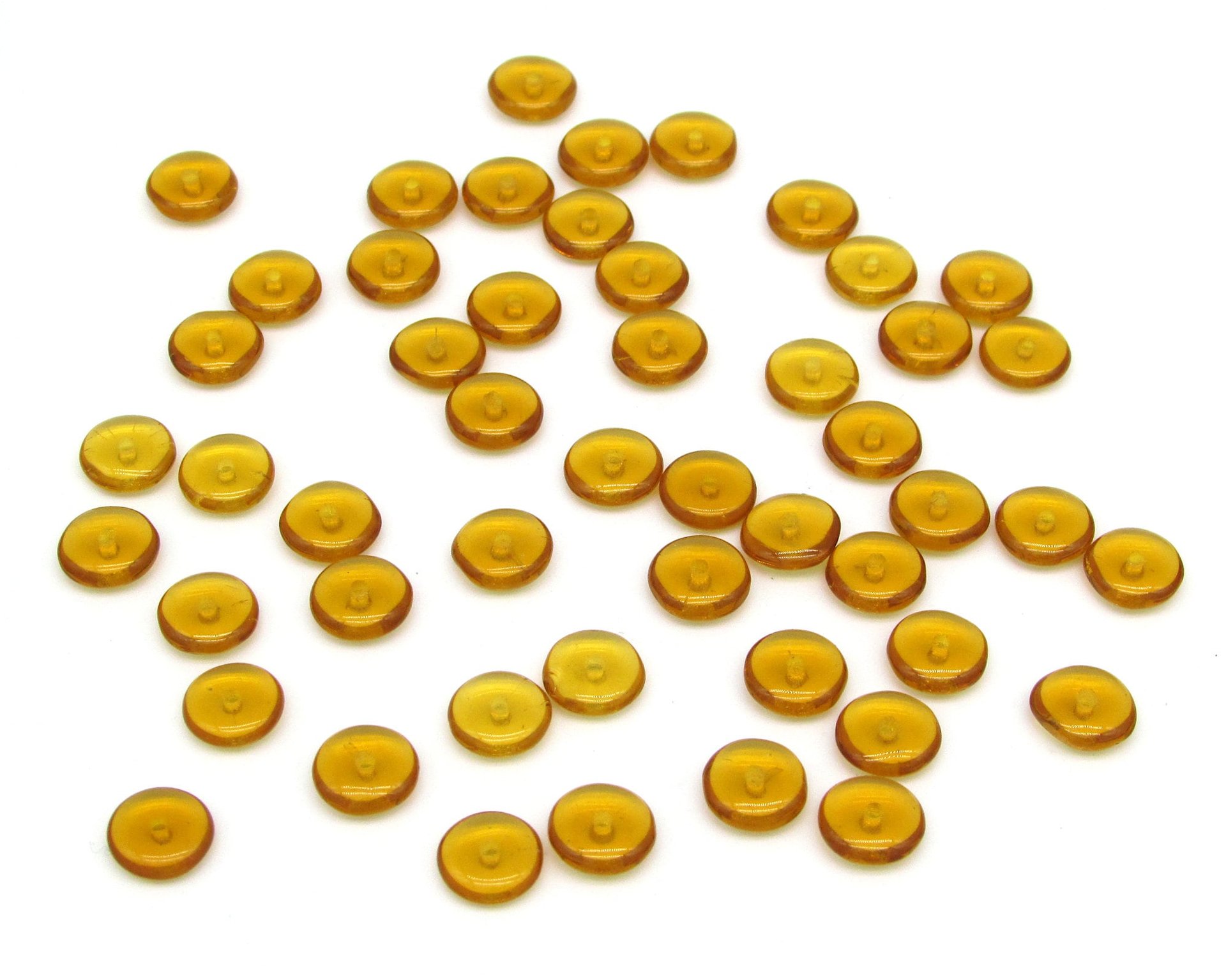 Translucent pressed glass rondelles are thin, round unfaceted disc beads measuring 7mm in diameter and 3mm thick with 1mm front-drilled holes. 50 piece lots are available in topaz, taupe, aqua, purple, and light green.