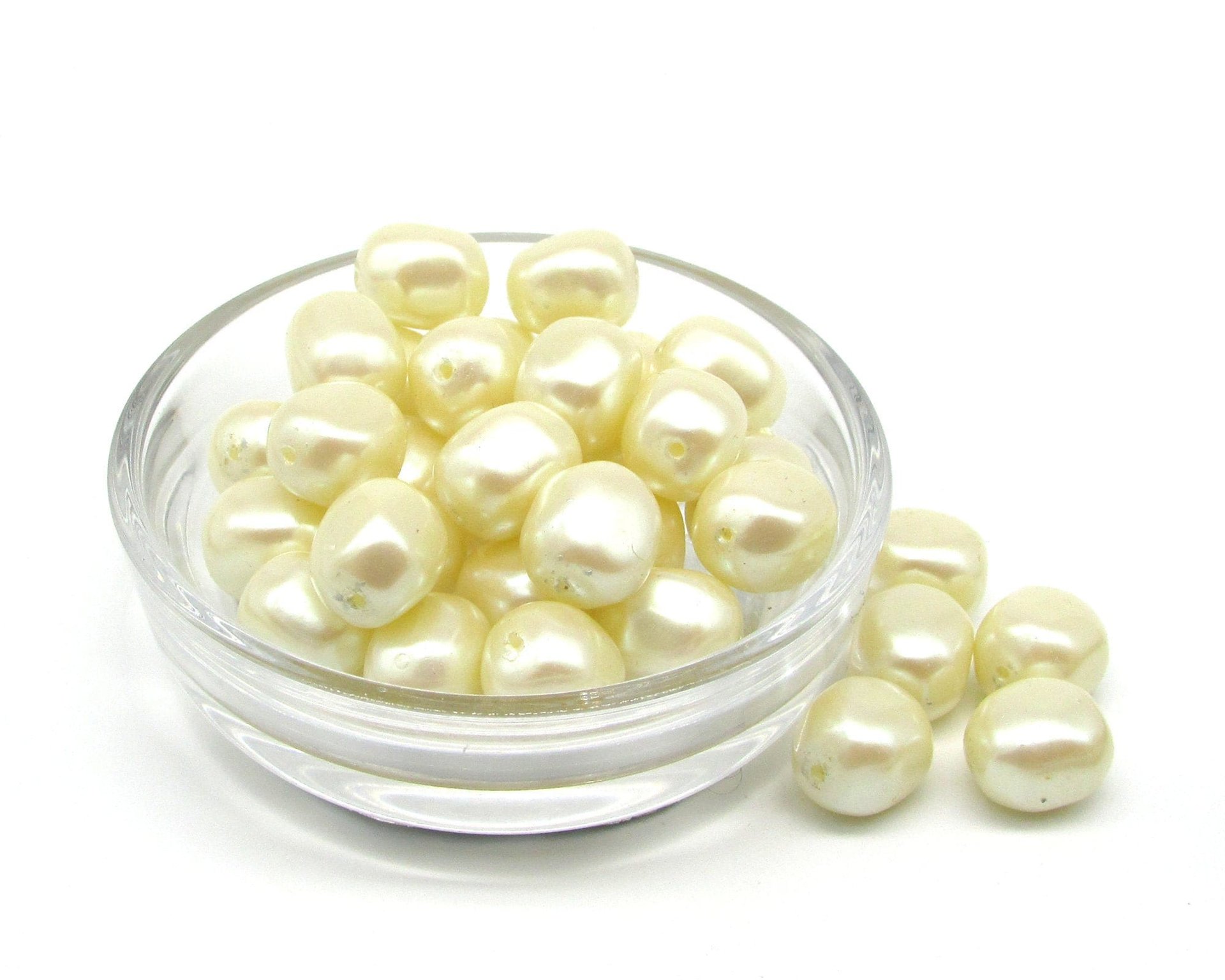 Vintage opaque cream pearlized plastic nugget beads measure approximately 12mm long and 10.5mm wide, with center-drilled 1.0mm lengthwise holes.