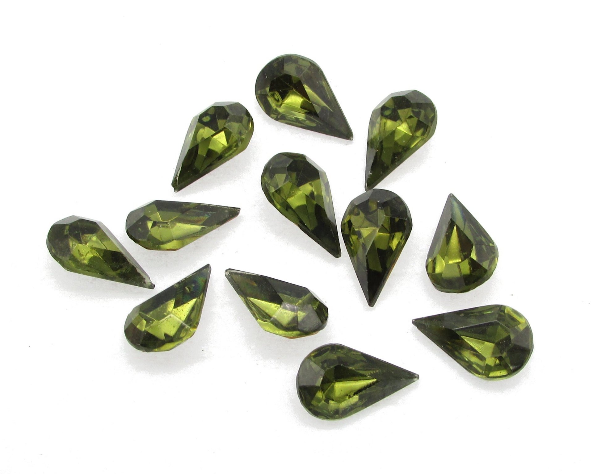 Vintage tin table cut pear shape rhinestones are translucent dark olive green backed with gold foil. Point back stones measure 13mm long and 8mm wide.