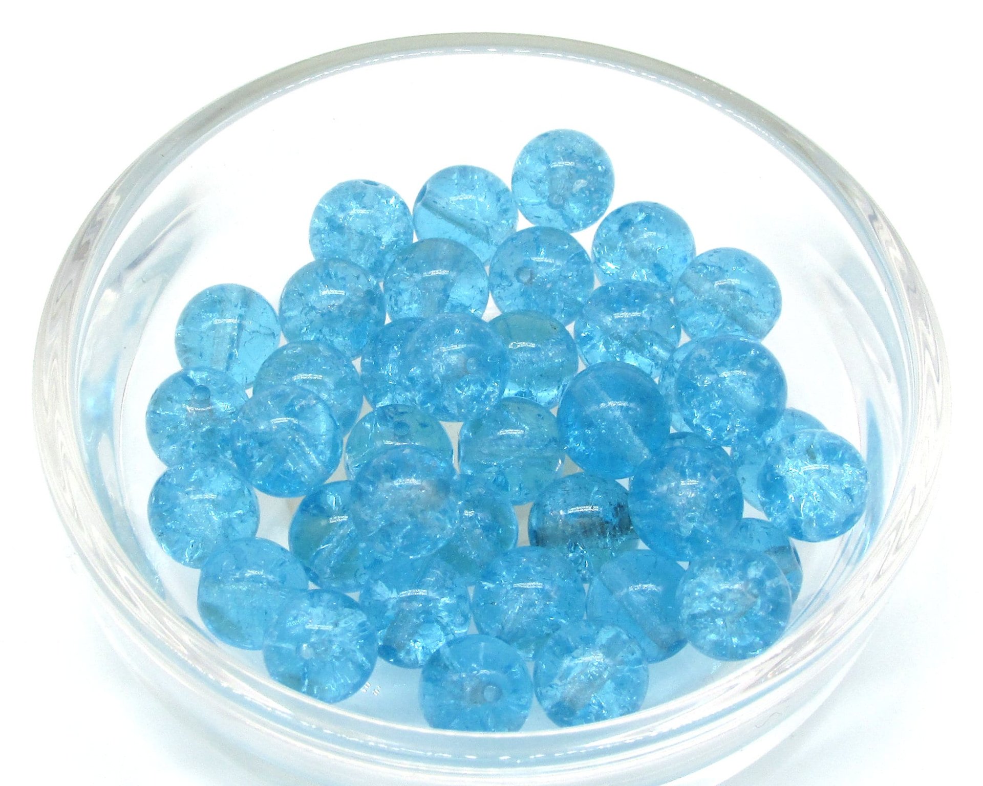 Round crackled glass beads measure 8mm in diameter with center-drilled 1mm holes. Available in several translucent colors.