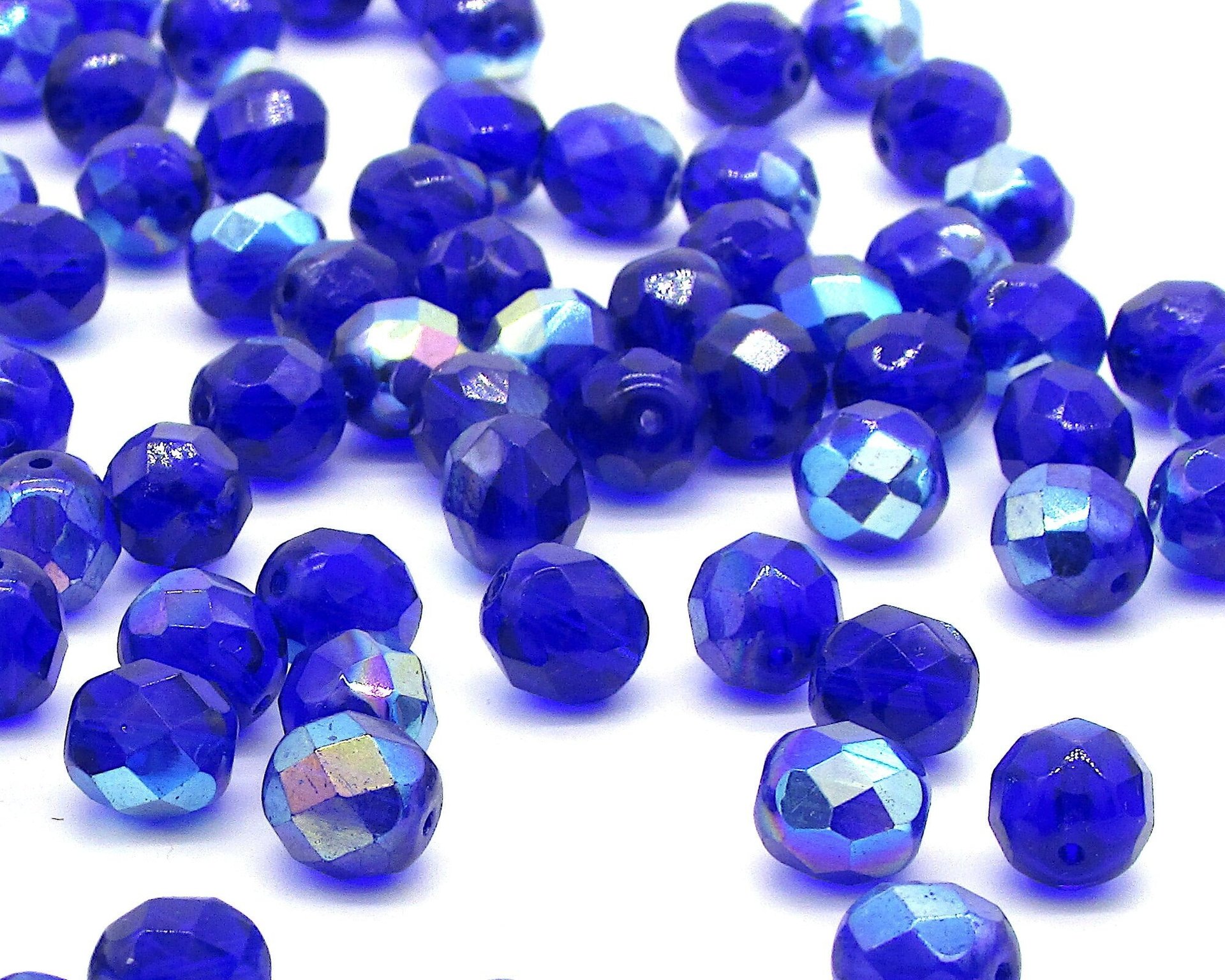 Iridescent blue Czech glass beads are fire polished rounds measuring approximately 8mm long and 7.5mm wide, with an approximate hole size of 1.25mm.