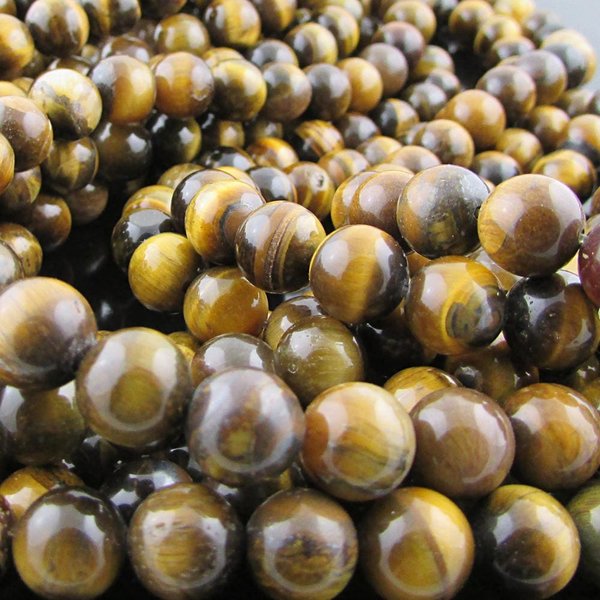 Natural tiger eye beads dark golden brown with a banded "cat's eye" effect. Round beads measure 8mm in diameter with 0.8mm stringing holes.
