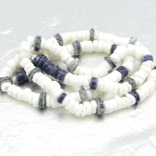 15 inch strand of vintage heishi beads has 189 flat, round beads center-drilled with 1mm holes. The strand rustic, unfaceted rondelles has 35 dark blue and 154 opaque white glass beads. 